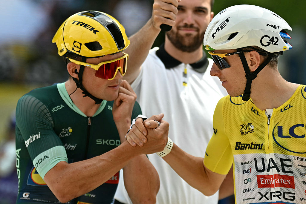 Lidl - Trek team's Danish rider Mads Pedersen wearing the sprinter's green jersey shakes hands with UAE Team Emirates - XRG's Slovenian rider Tadej Pogacar wearing the overall leader's yellow jersey at the start of the 13th stage of the 113th edition of the Tour de France cycling