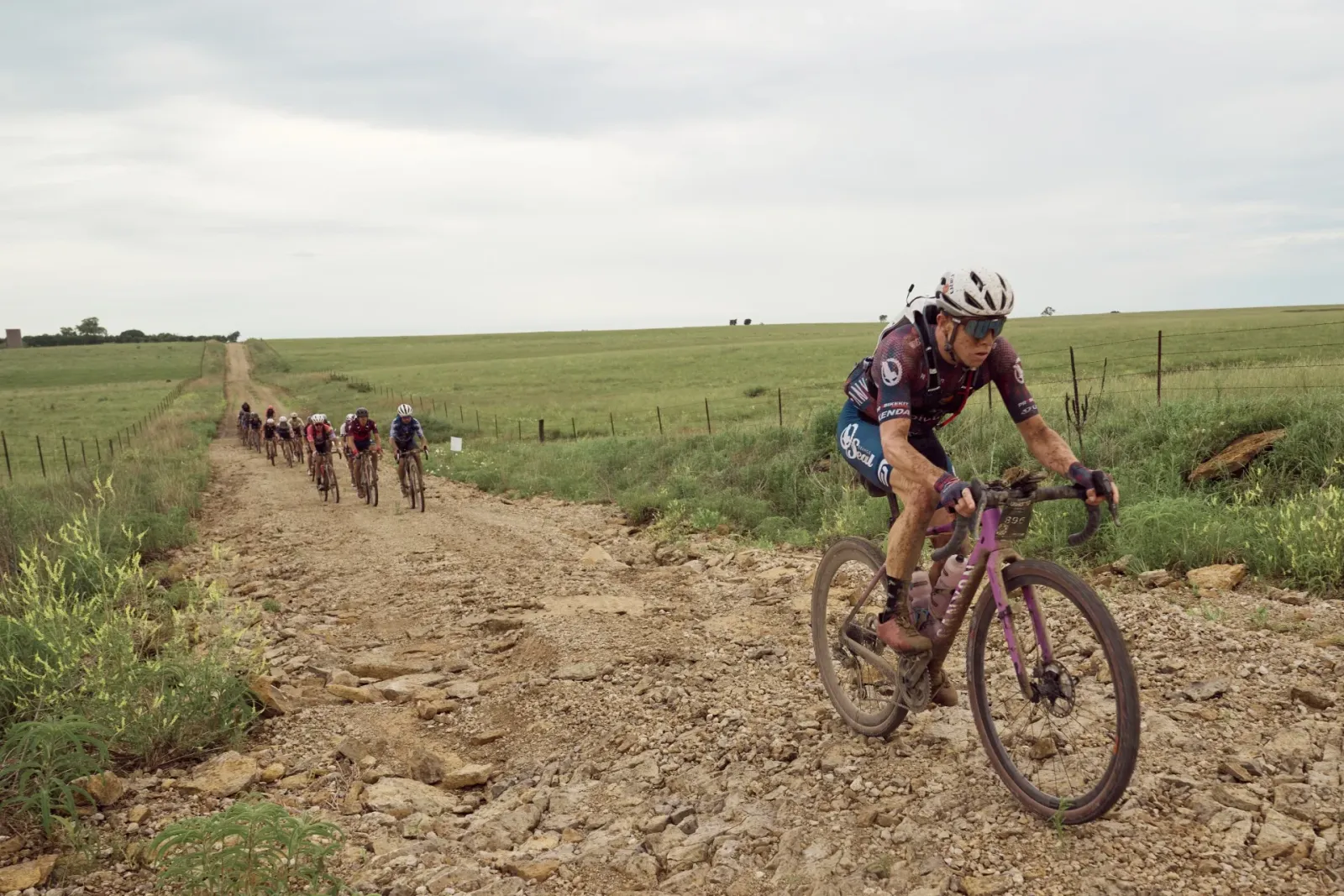 Cyklista na kamenitém terénu při jízdě do kopce během gravelu Unbound 200